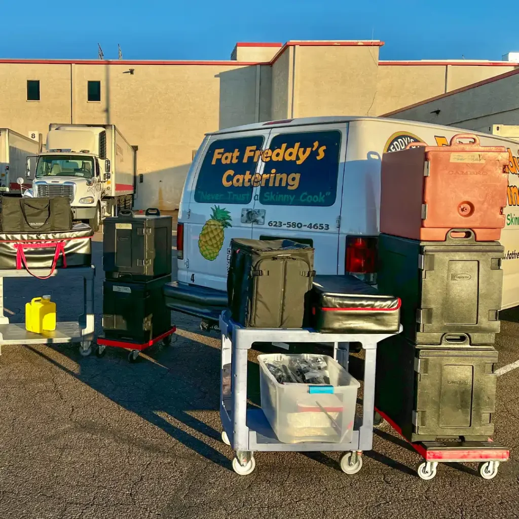 Fat Freddy's Van offloading BBQ Catering meal in the back of a business