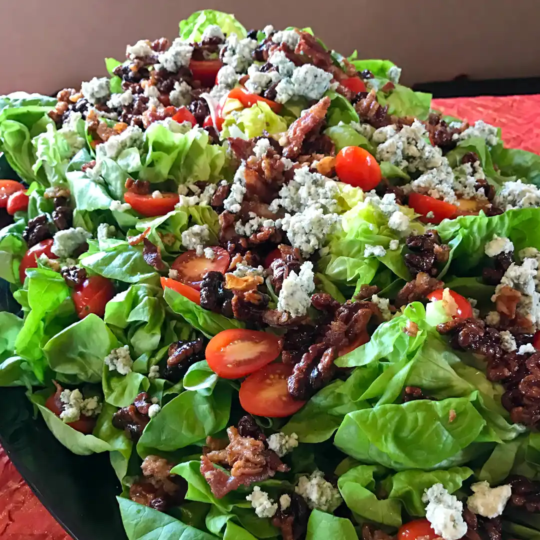 spinach salad with tomatoes, walnuts and bleu cheese on a buffet in tempe