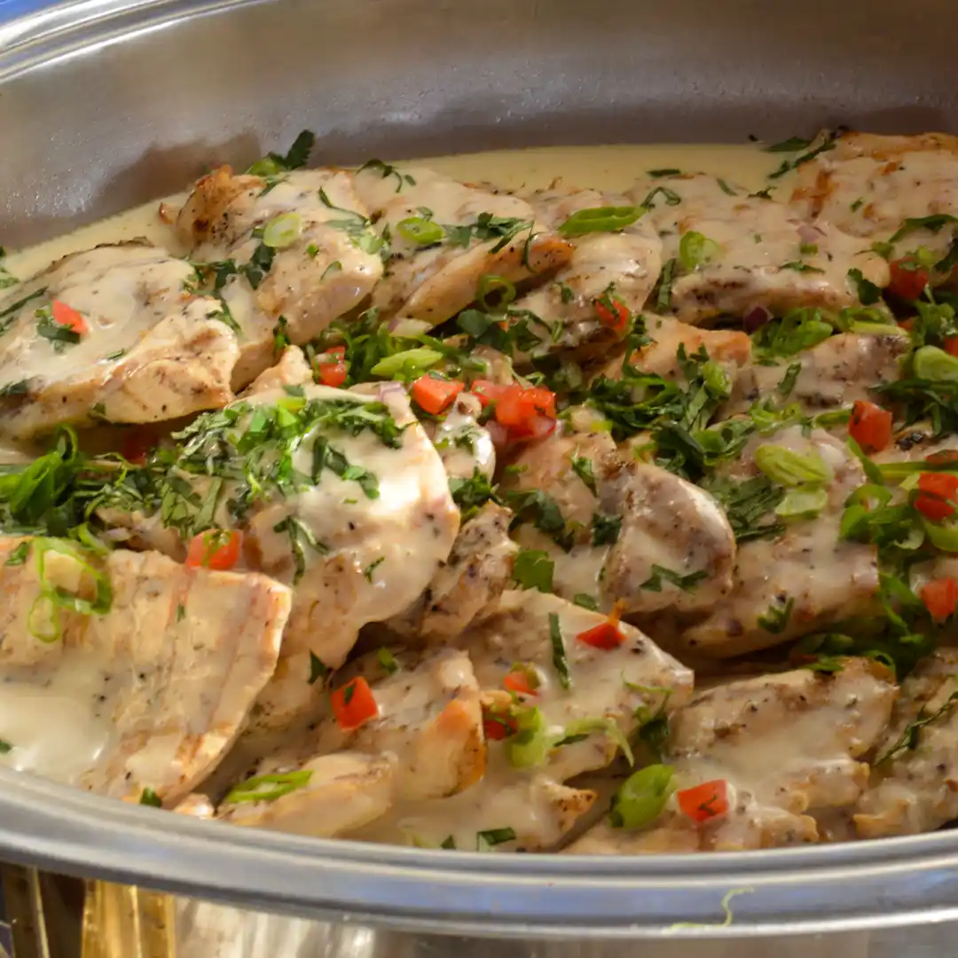 White burgundy chicken in an oval pan served in peoria