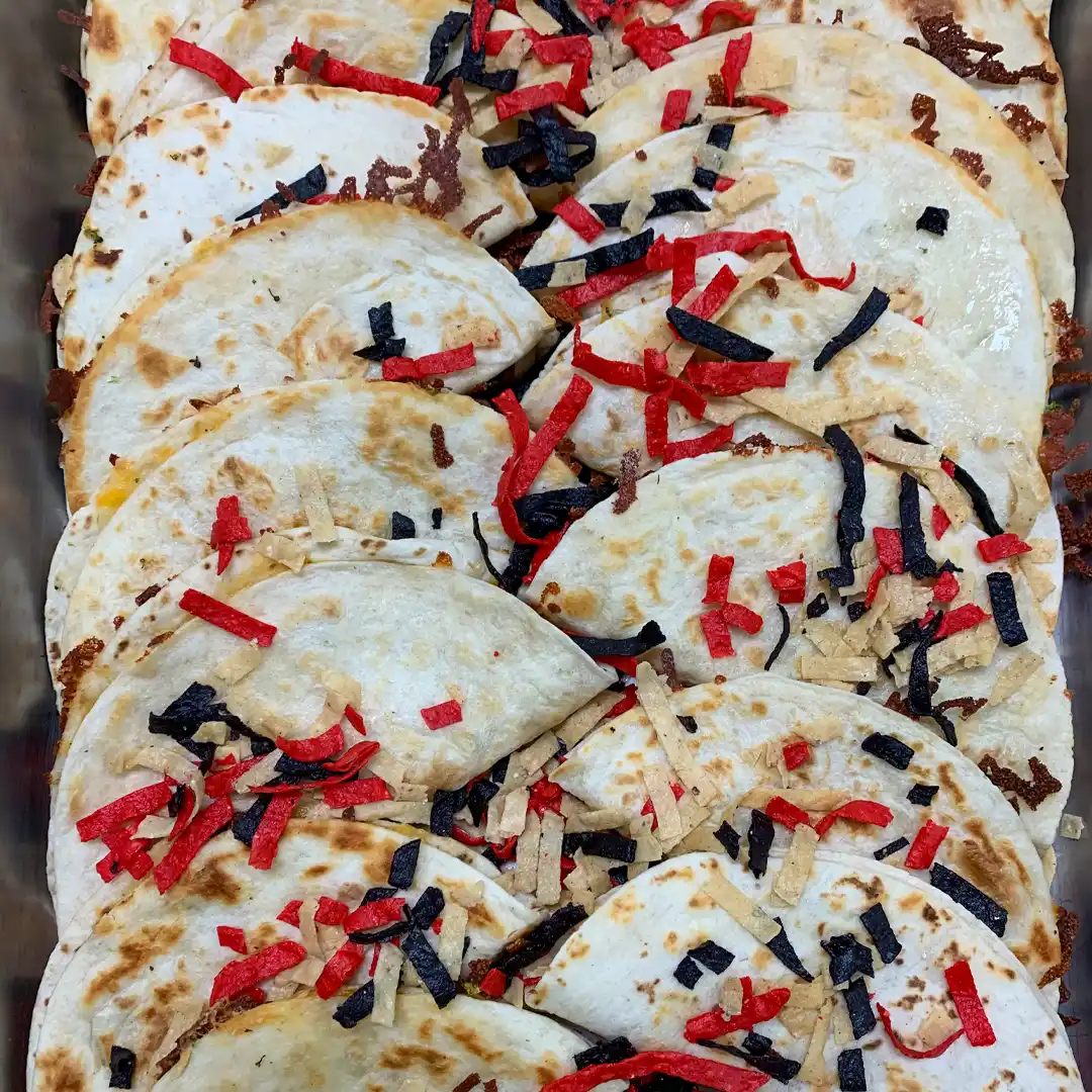grilled quesadillas in a chaffer pan by fat Freddy's Catering