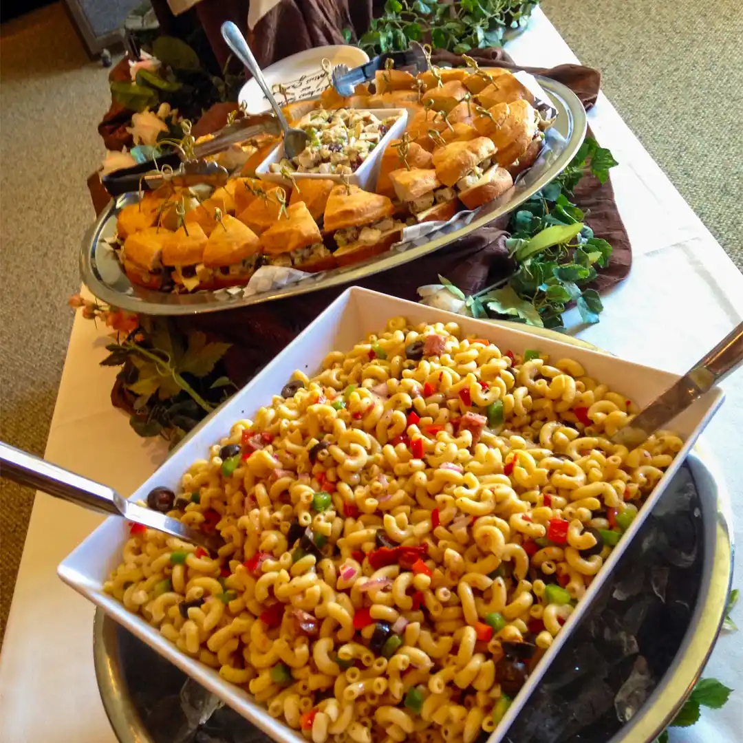 pasta salad and sandwiches displayed on a buckeye catering buffet